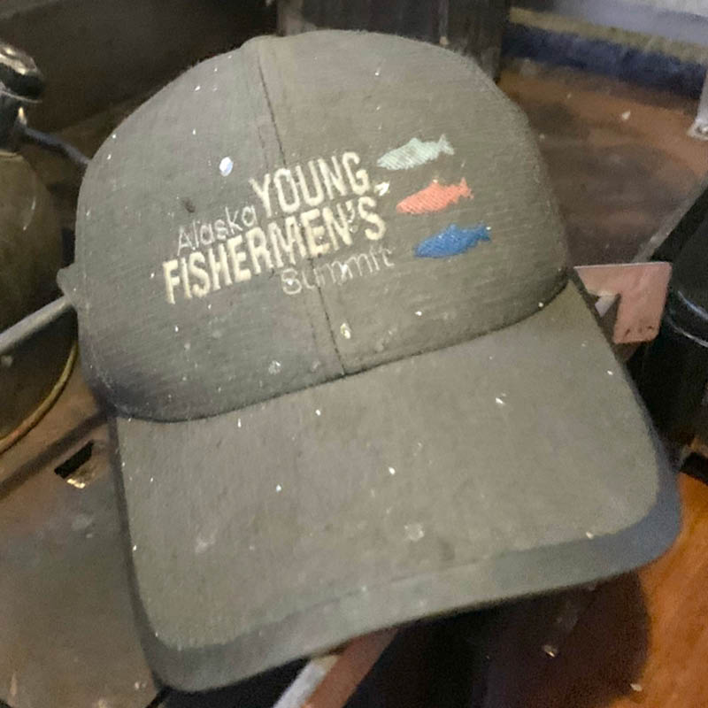 a wet ballcap with a logo for Alaska Young Fishermen's Summit