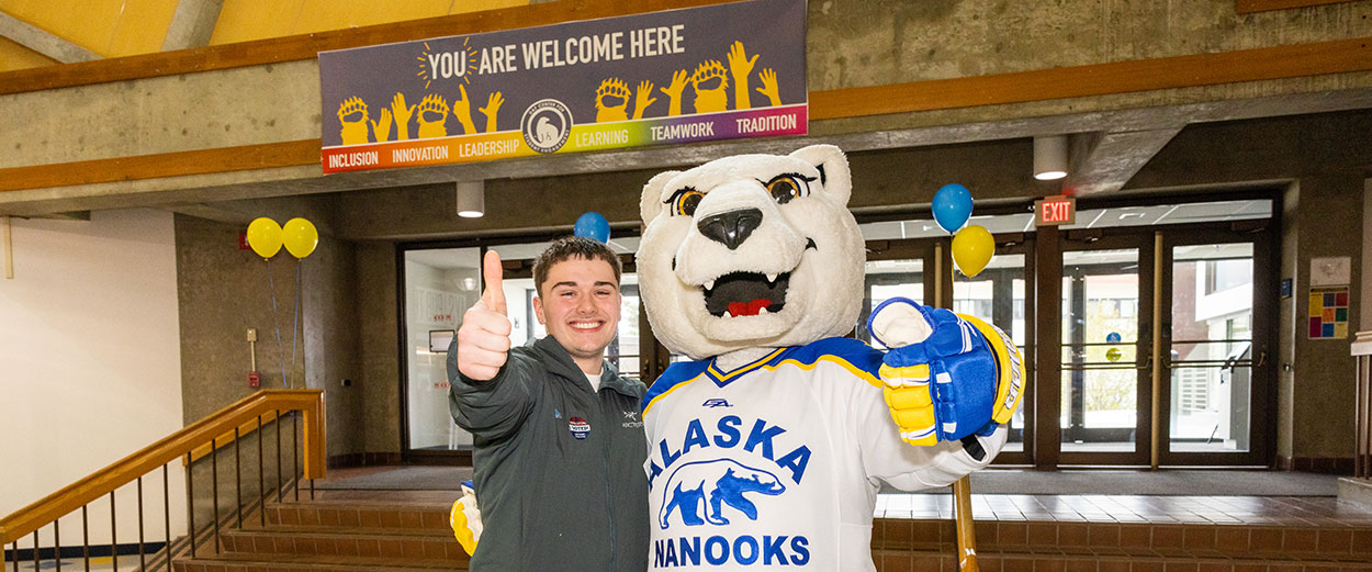 A 无码乱伦 student poses with the Nook mascot inside the Wood Center student union on the Fairbanks Troth Yeddha campus.