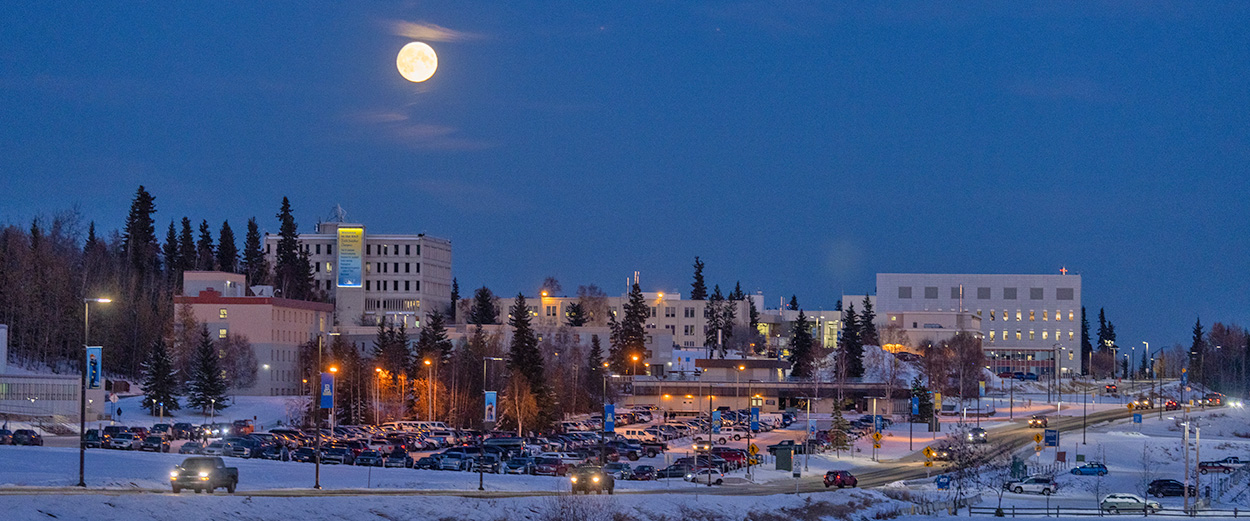 A winter full moon shines over the lower 无码乱伦 Troth Yeddha campus in Fairbanks